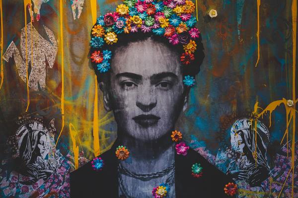 A creative graffiti wall portrait of frida kahlo
