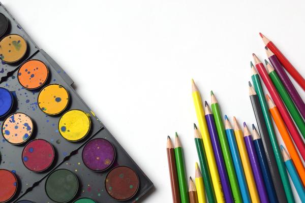 A photo illustration of back to school pencils with different colors of paint on a white platform