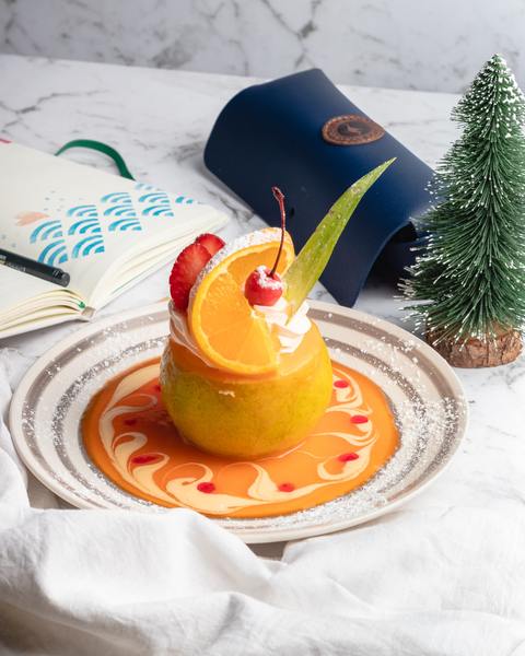 A photo of an orange fruit on a colored saucer