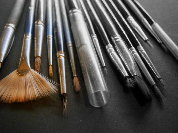 A photo of various sizes of paint brushes and a hollyhock second hand